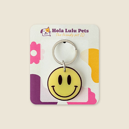 Classic yellow smiley face happy illustration on a durable white acrylic QR code pet tag by Hola Lulu Pets.