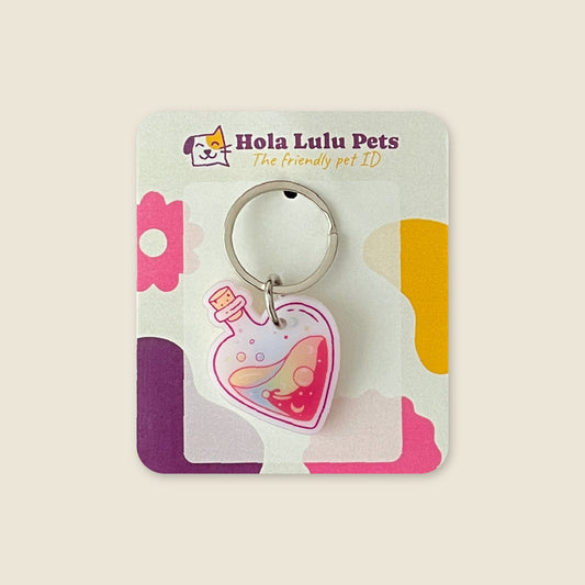 "Love Potion" magic heart bottle illustration on a durable white acrylic QR pet tag by Hola Lulu Pets.